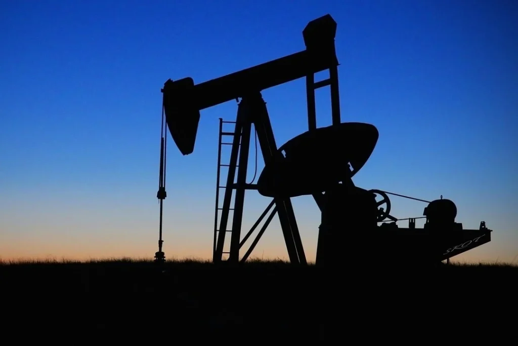 Oil pumpjack silhouette against a twilight sky, symbolizing global dependence on fossil fuels in 2025.