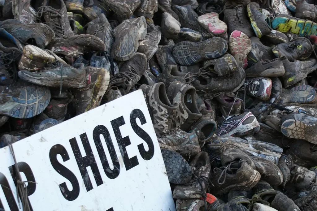 Pile of discarded shoes illustrating footwear waste and environmental impact